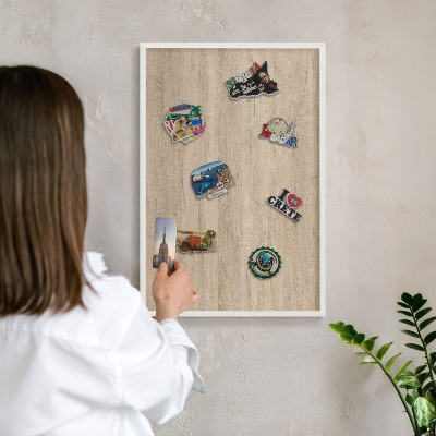 Decorative magnet board with a white frame Wooden background