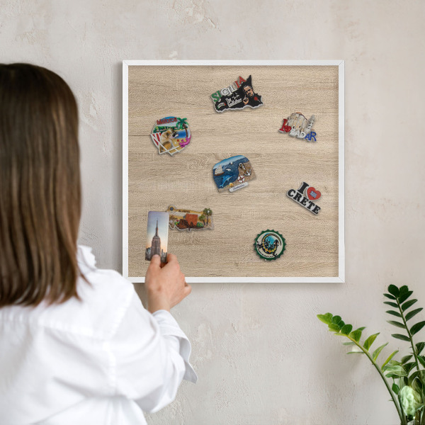 Decorative magnet board with a white frame Wooden background