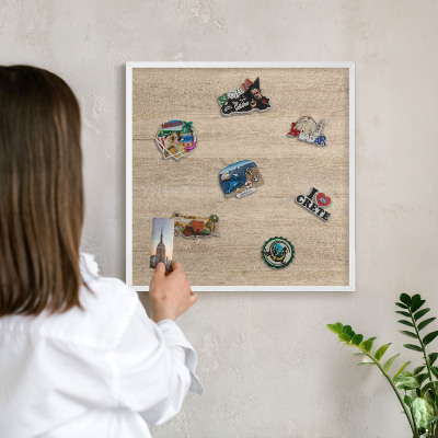 Decorative magnet board with a white frame Wooden background