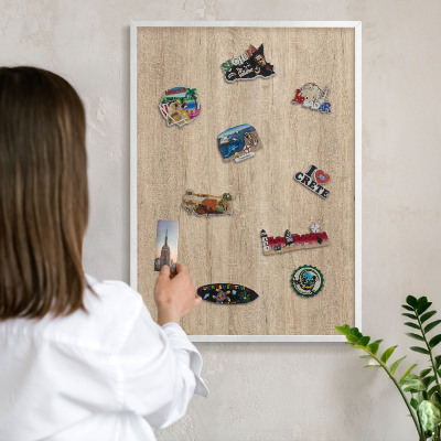 Decorative magnet board with a white frame Wooden background