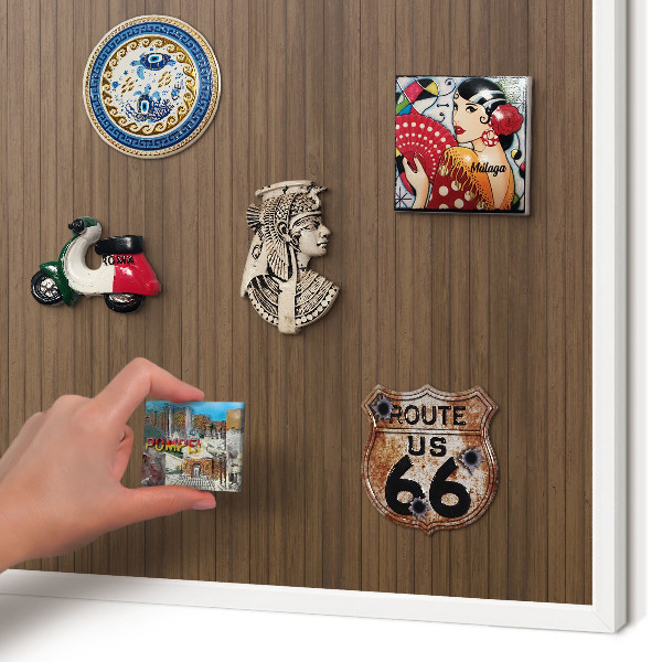 Magnetic board for travel magnets in a white frame Wooden background