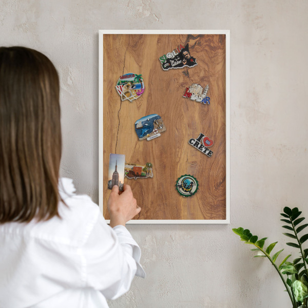 Magnetic board for travel magnets in a white frame Natural wood