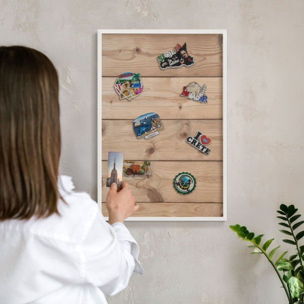 Magnetic board for travel magnets in a white frame Wooden texture