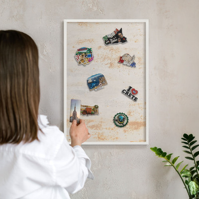 Magnetic board for travel magnets in a white frame Rusty texture