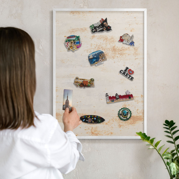 Magnetic board for travel magnets in a white frame Rusty texture