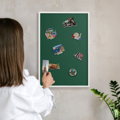 Magnetic board for travel magnets in a white frame Bottle green
