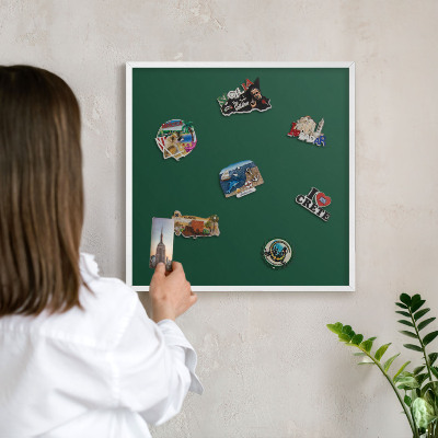 Magnetic board for travel magnets in a white frame Bottle green