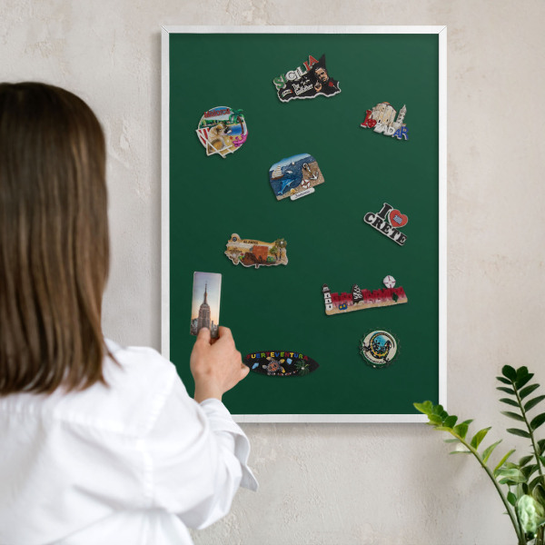 Magnetic board for travel magnets in a white frame Bottle green
