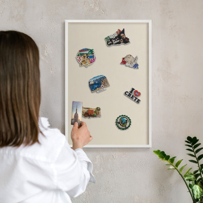 Magnetic board for travel magnets in a white frame Light stone