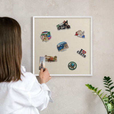 Magnetic board for travel magnets in a white frame Light stone
