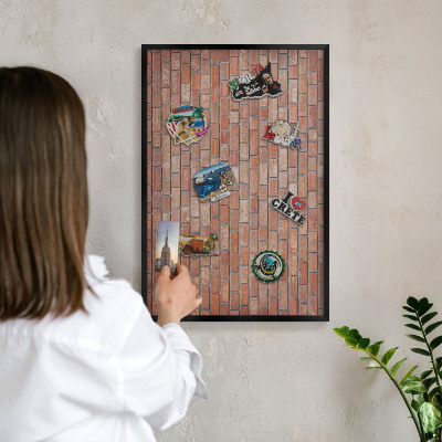Metal wall board for magnets in a black frame Brick wall