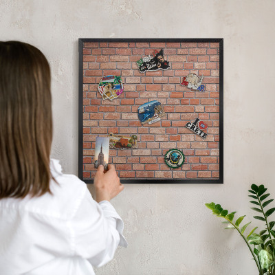 Metal wall board for magnets in a black frame Brick wall