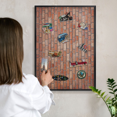 Metal wall board for magnets in a black frame Brick wall