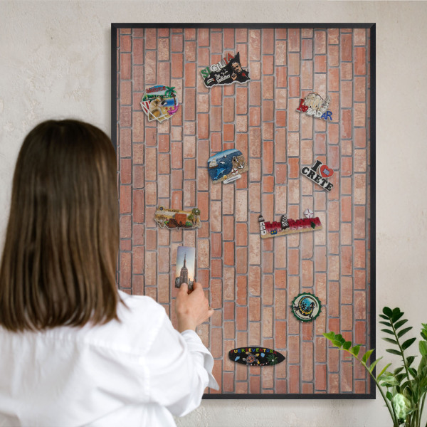 Metal wall board for magnets in a black frame Brick wall