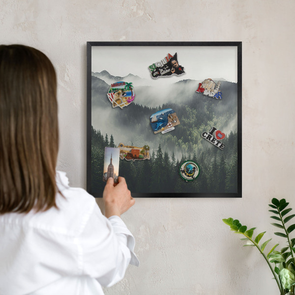 Vacation magnet board with a black frame Green mountains
