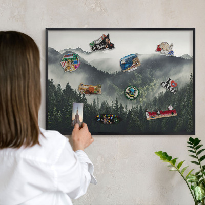 Vacation magnet board with a black frame Green mountains