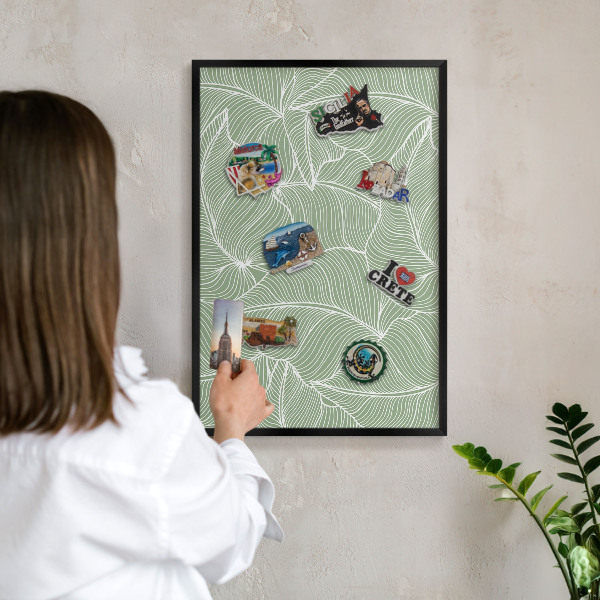 Metal wall board for magnets in a black frame Tropical leaves