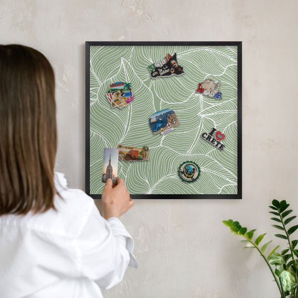 Metal wall board for magnets in a black frame Tropical leaves