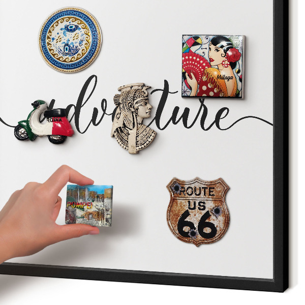 Vacation magnet board with a black frame Adventure written