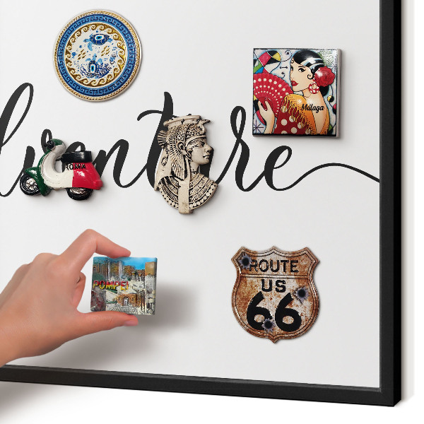 Vacation magnet board with a black frame Adventure written