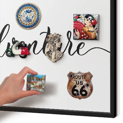 Vacation magnet board with a black frame Adventure written