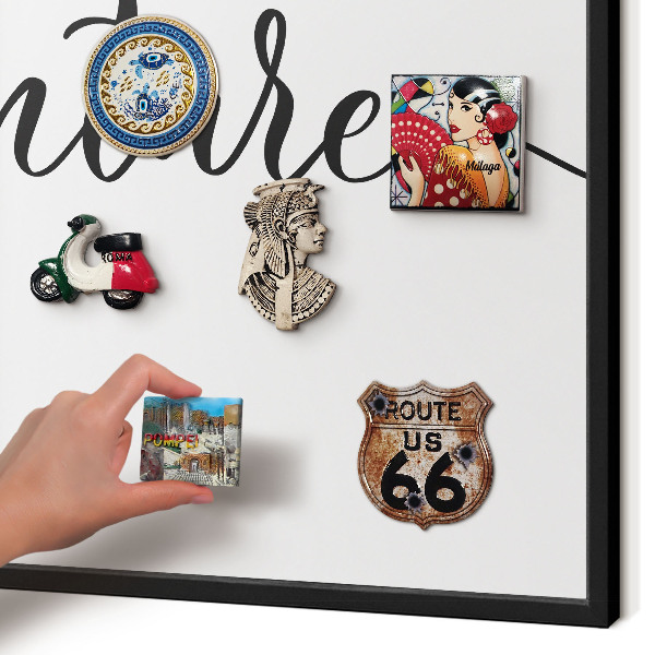Vacation magnet board with a black frame Adventure written