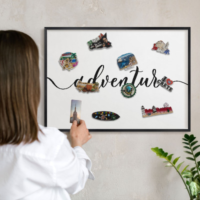 Vacation magnet board with a black frame Adventure written