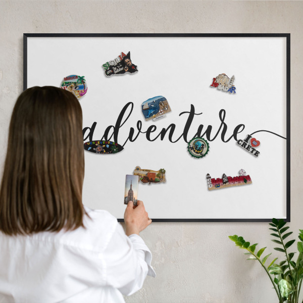 Vacation magnet board with a black frame Adventure written