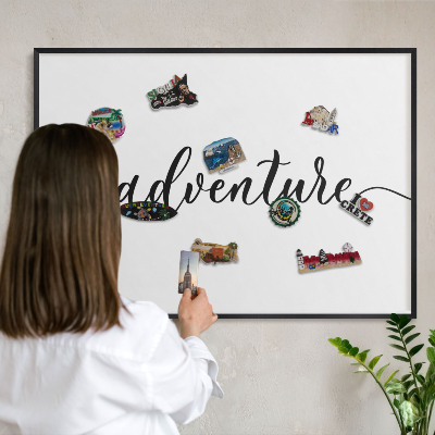 Vacation magnet board with a black frame Adventure written