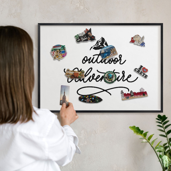 Metal wall board for magnets in a black frame Mountain adventure