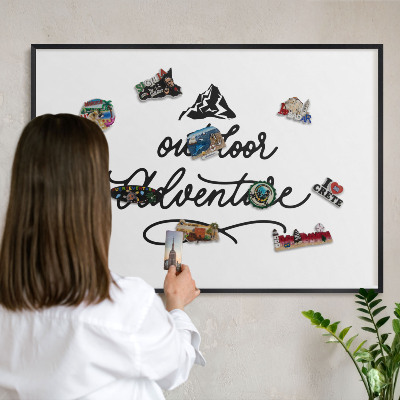 Metal wall board for magnets in a black frame Mountain adventure