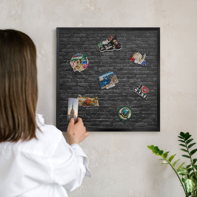 Metal wall board for magnets in a black frame Brick wall