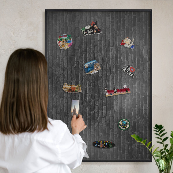 Metal wall board for magnets in a black frame Brick wall
