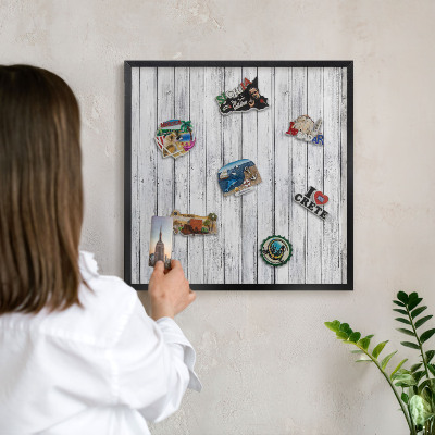 Metal wall board for magnets in a black frame Light wood