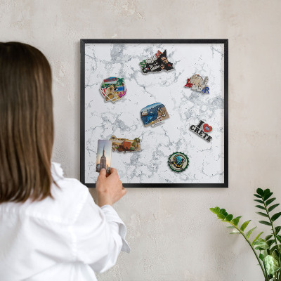 Metal wall board for magnets in a black frame Marble aesthetics