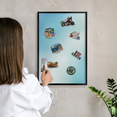 Metal wall board for magnets in a black frame Blue sky