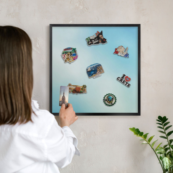 Metal wall board for magnets in a black frame Blue sky