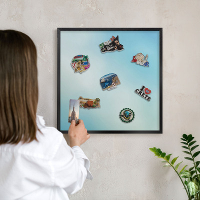 Metal wall board for magnets in a black frame Blue sky