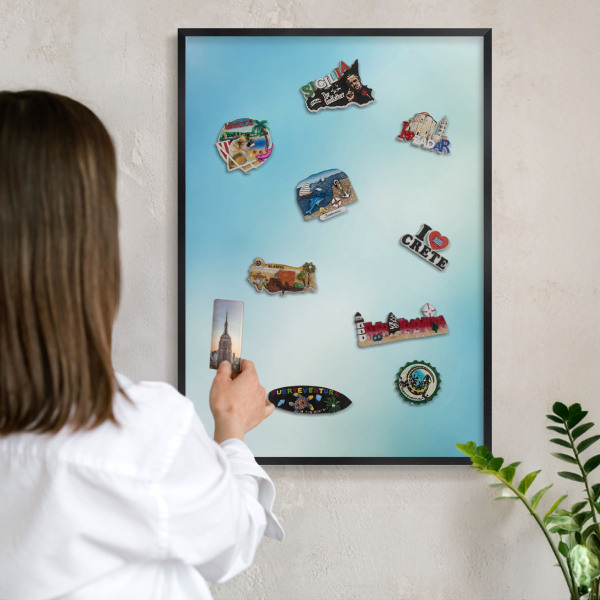Metal wall board for magnets in a black frame Blue sky