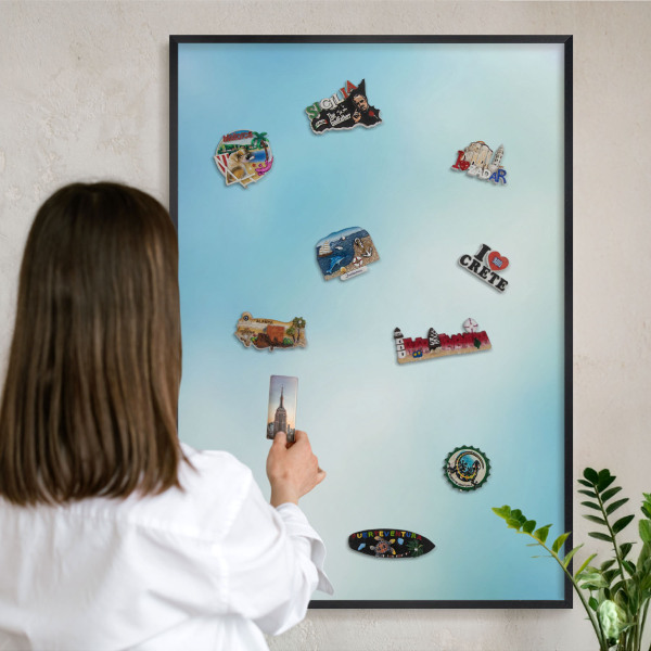 Metal wall board for magnets in a black frame Blue sky