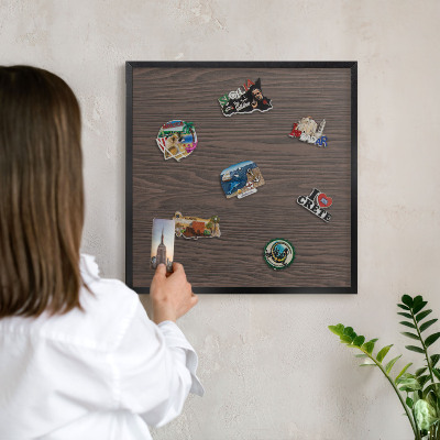 Metal wall board for magnets in a black frame Natural wood
