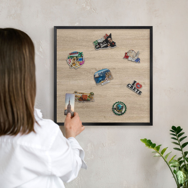 Vacation magnet board with a black frame Wooden background