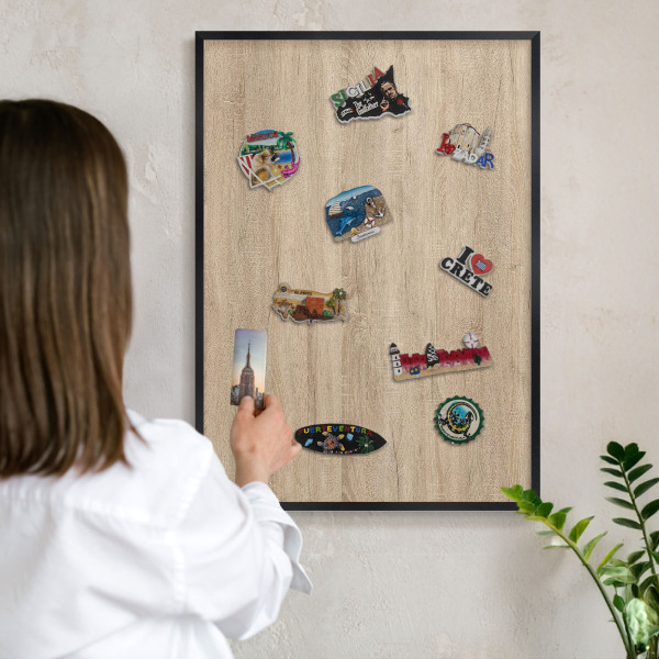 Vacation magnet board with a black frame Wooden background