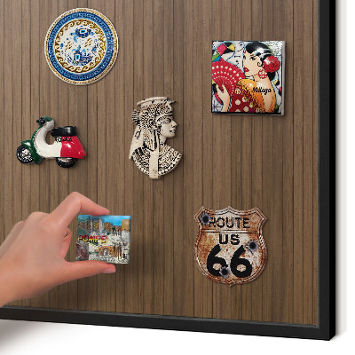 Metal wall board for magnets in a black frame Wooden background