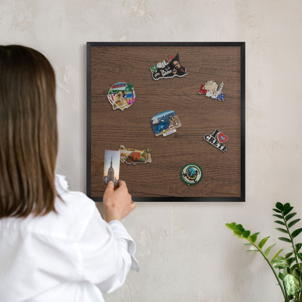 Metal wall board for magnets in a black frame Wooden texture