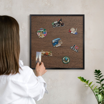 Metal wall board for magnets in a black frame Wooden texture