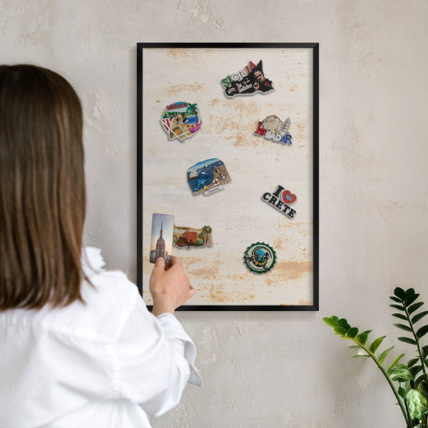 Metal wall board for magnets in a black frame Rusty texture