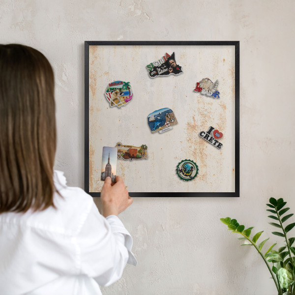 Metal wall board for magnets in a black frame Rusty texture