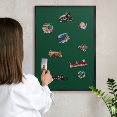 Metal wall board for magnets in a black frame Bottle green
