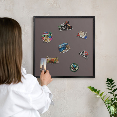 Metal wall board for magnets in a black frame Faded brown